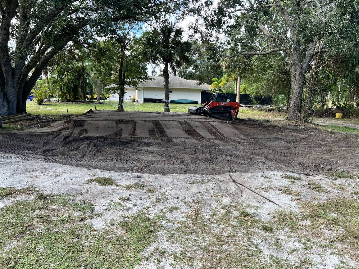 Building pad graded and compacted with a track loader on site