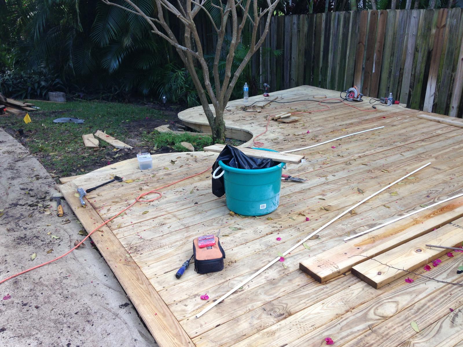 Deck boards going down over new framing on a backyard build