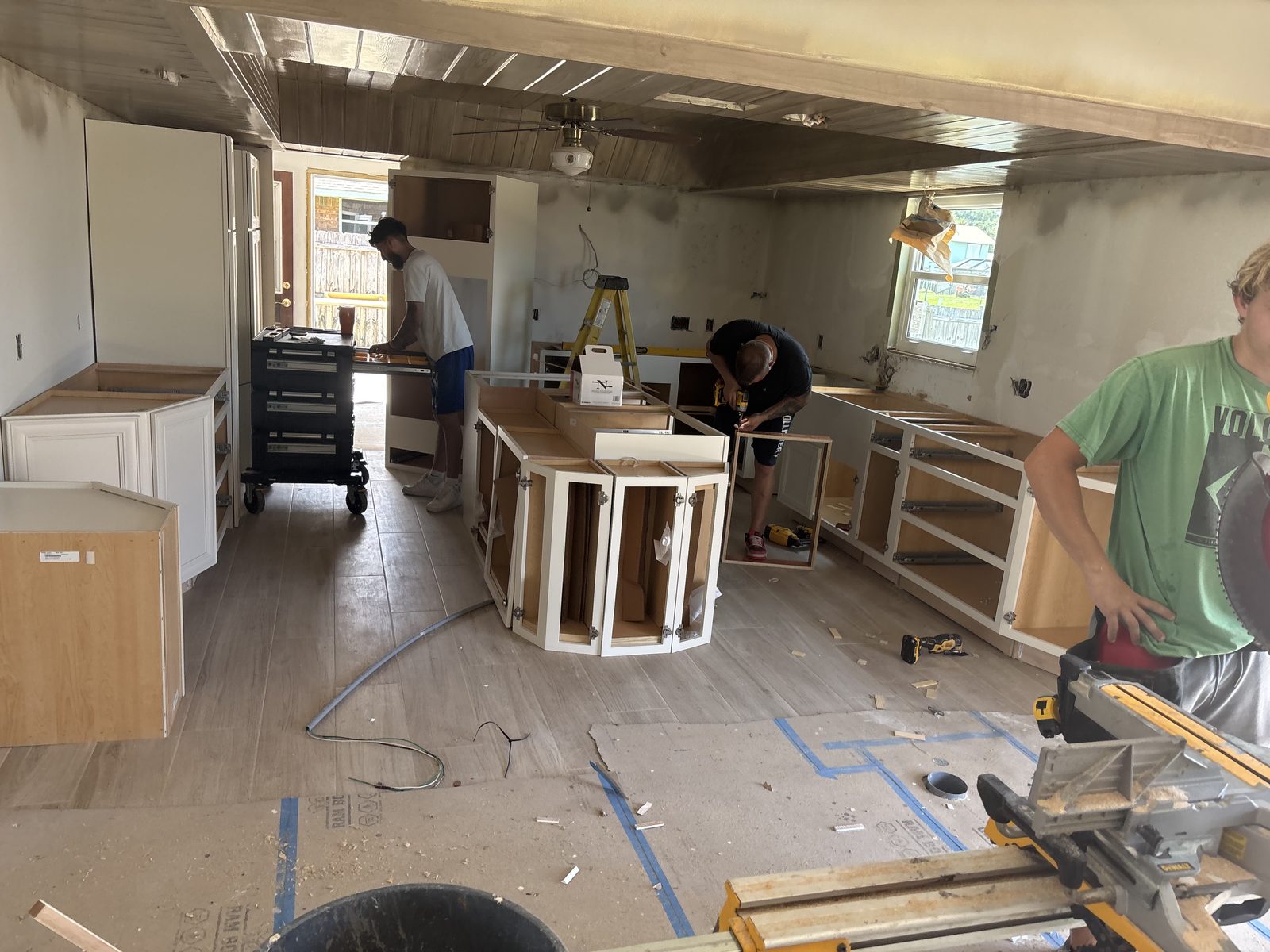 TradeWinds crew setting kitchen cabinets during a full remodel