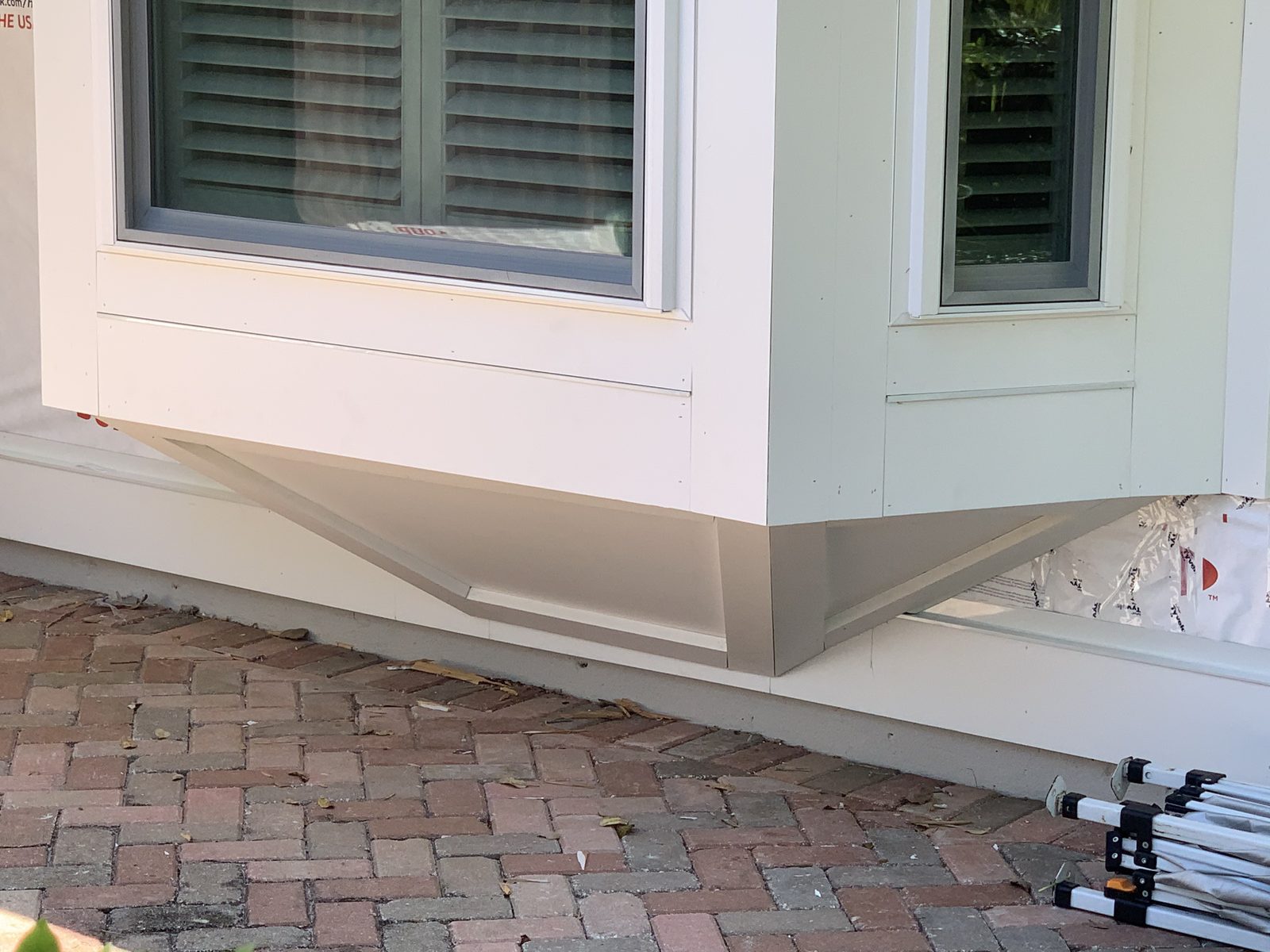 Bay window underside finished with siding and angled support brackets