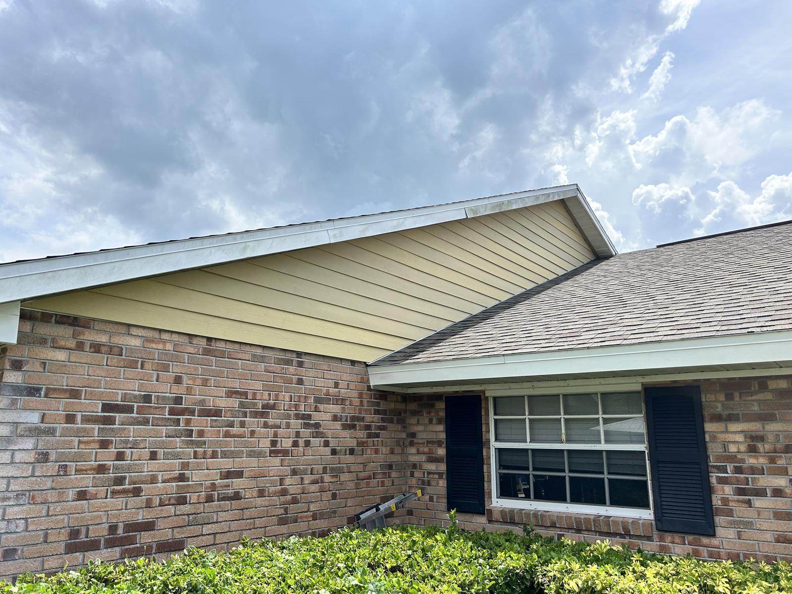 New soffit and fascia finished along the eaves of a brick home