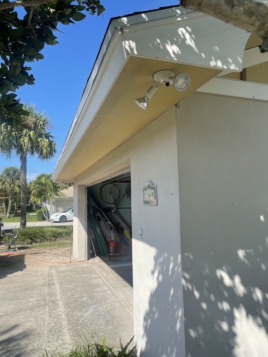Clean white soffit and fascia returning above a garage entry