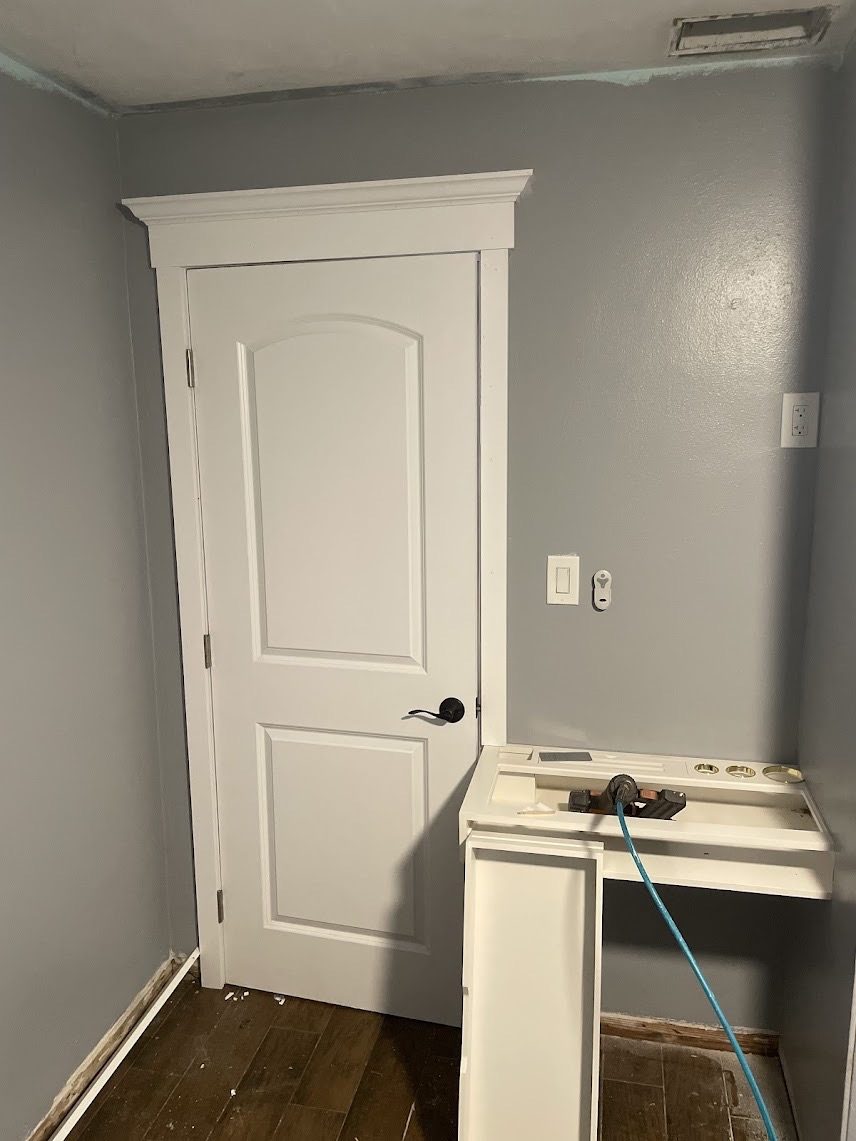 Interior door trimmed with a built-up header casing and crown cap