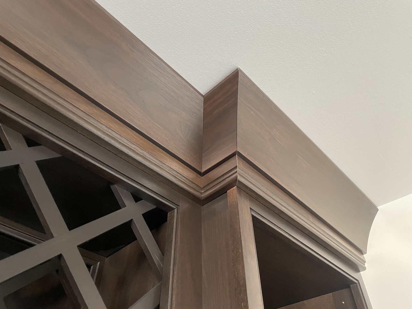 Stained cabinet crown molding mitered around an outside corner