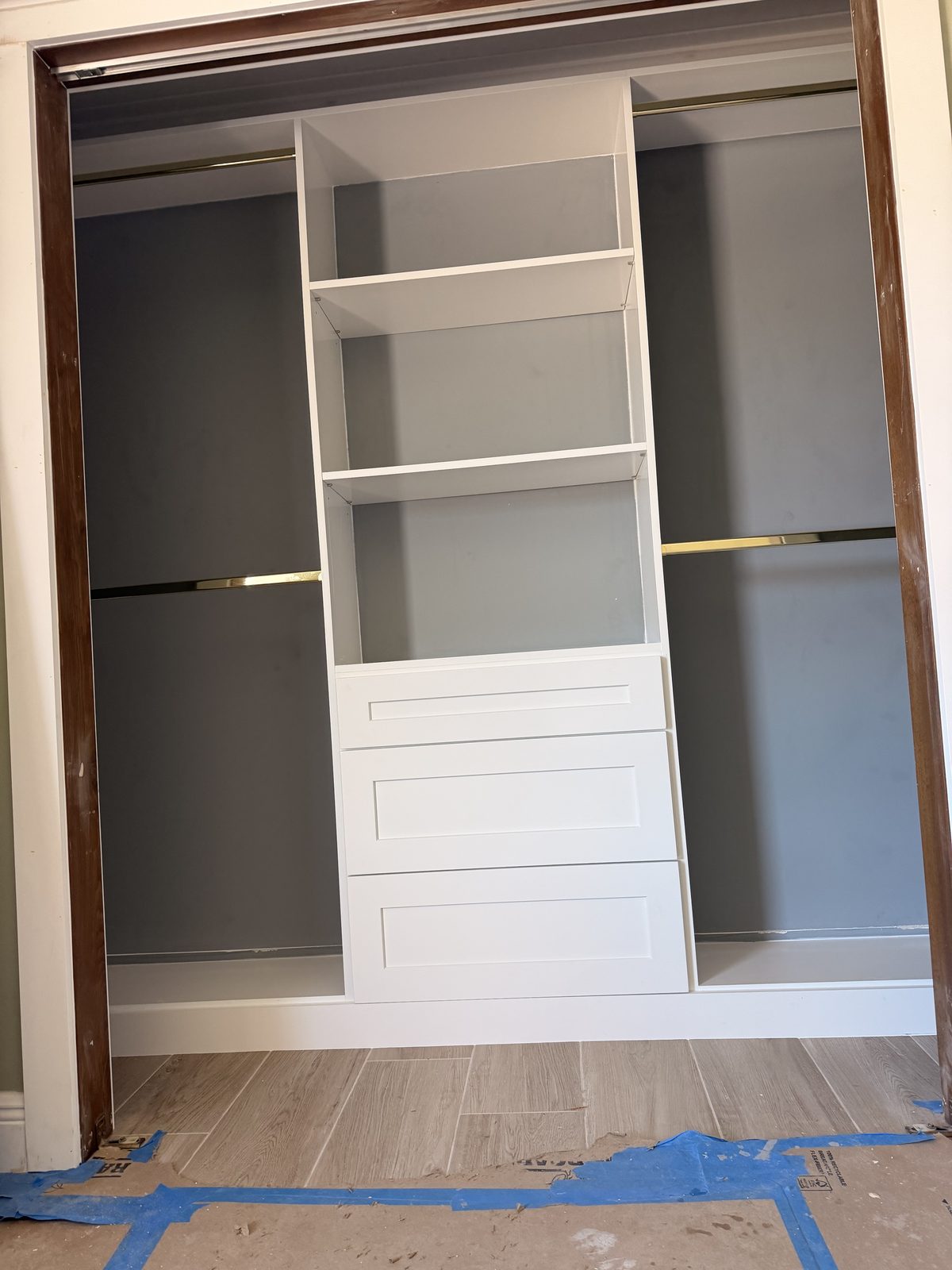 Custom closet build-out with banks of drawers and adjustable shelving