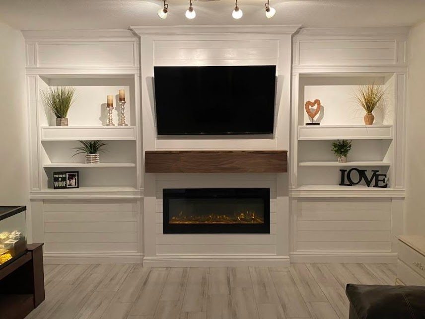 Built-in media wall with shiplap panels, open shelving and a wood mantel